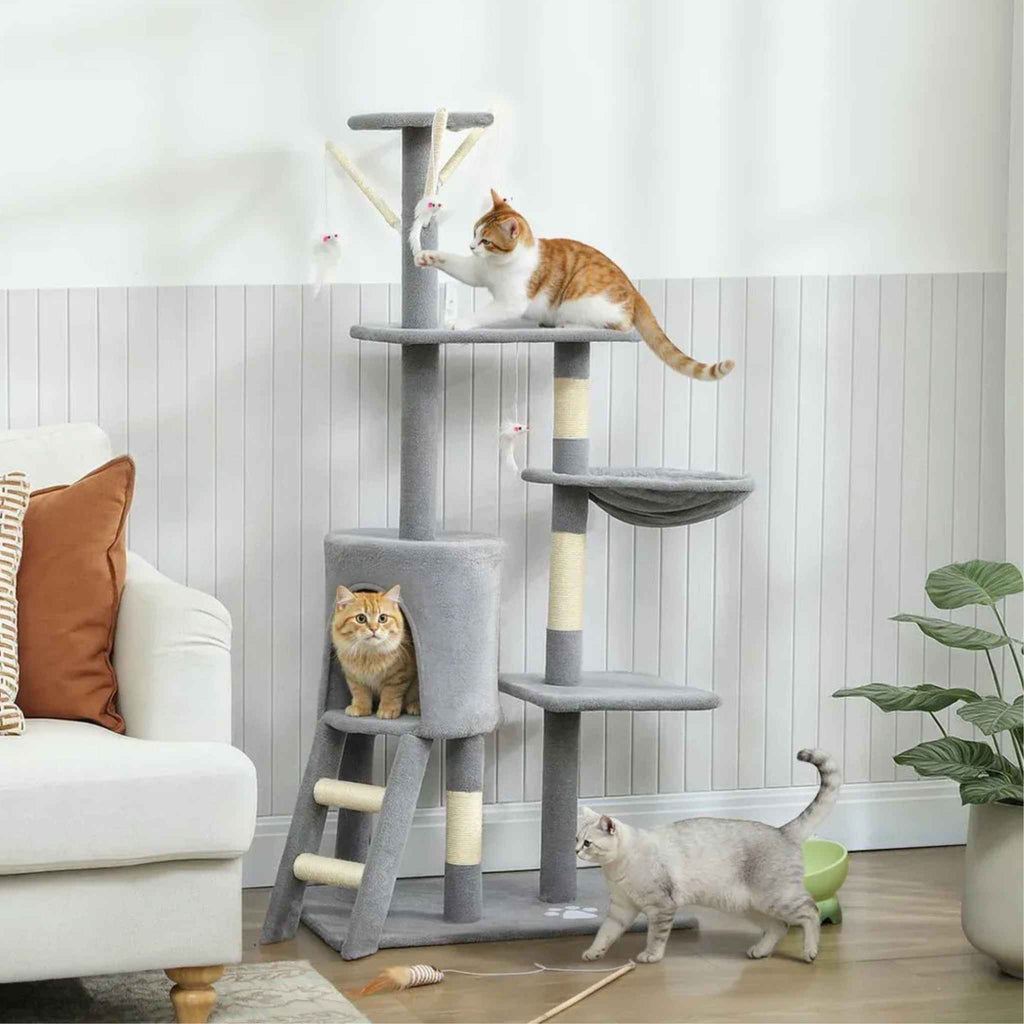 3 cats playing on grey fabric cat tree n living room