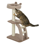 A brown tabby cat is climbing and stretching on a multi-level cat tree with a sisal-wrapped post and brown fabric platforms