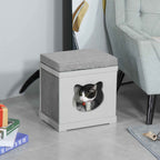 Black and white cat resting in grey wooden cat cave
