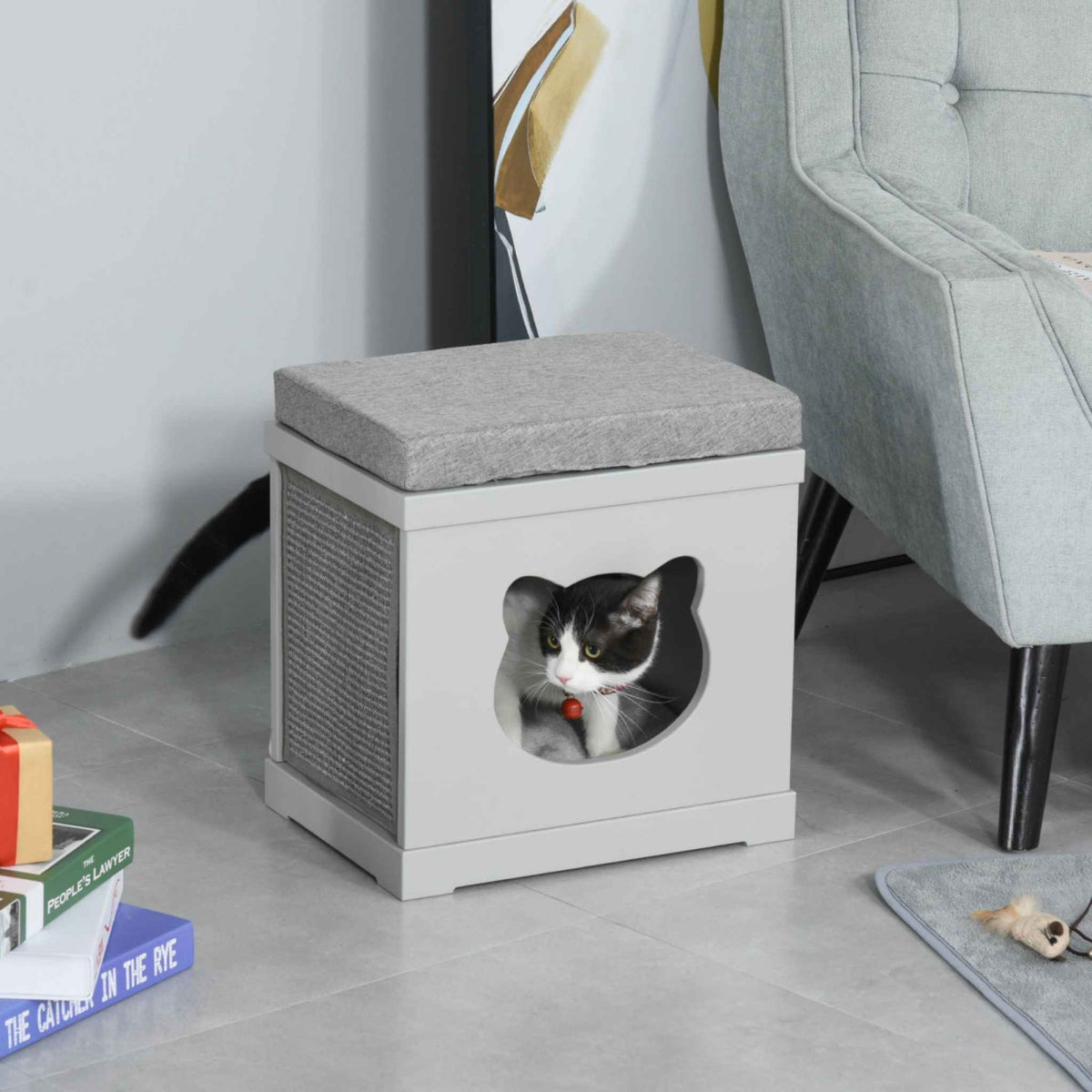 Black and white cat resting in grey wooden cat cave