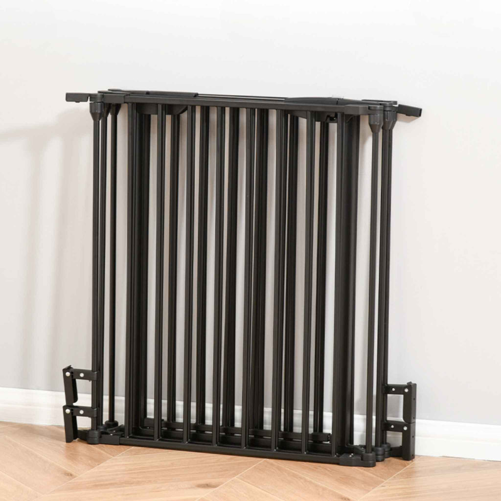 Black dog pen folded and stored against wall