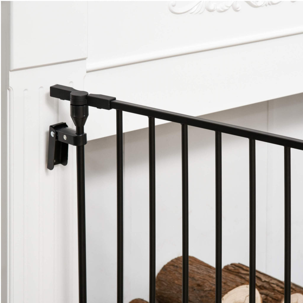 Black freestanding pet gate attached to wall