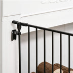Black freestanding pet gate attached to wall