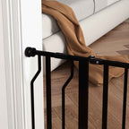 Black pet gate pressure fitted in door frame