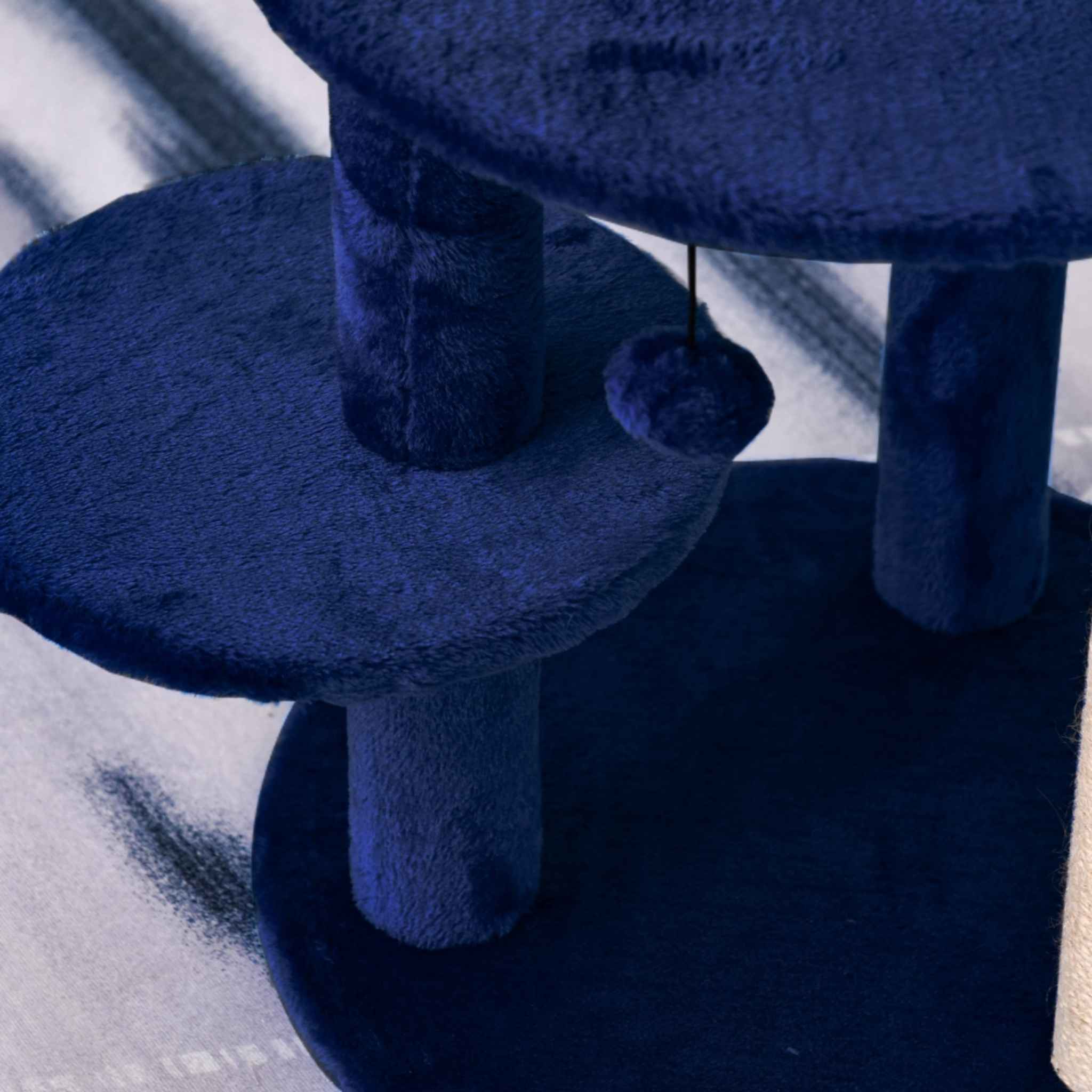 Blue plush fabric platforms on cat tree