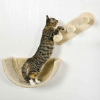 Cat climbing on beige wall mounted cat tree