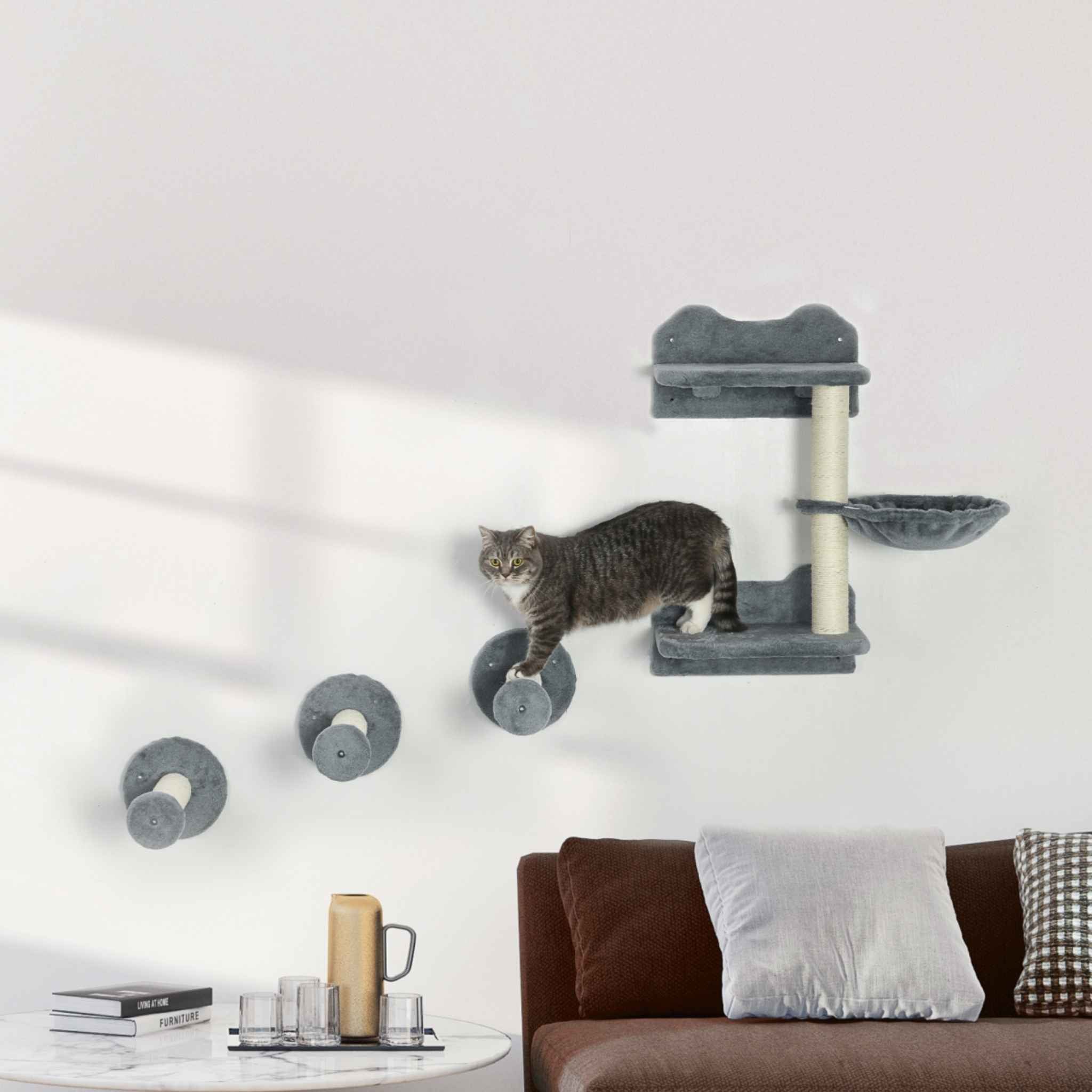 Cat climbing a wall-mounted cat tree in a living room
