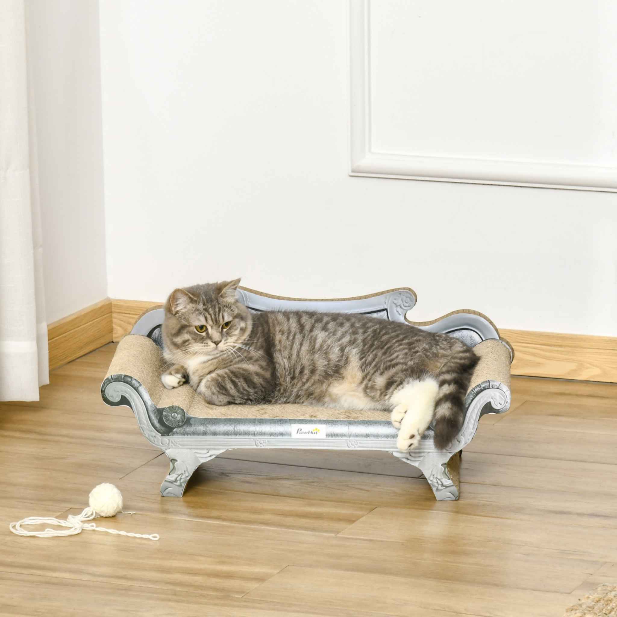 Cat laying on grey cardboard scratcher