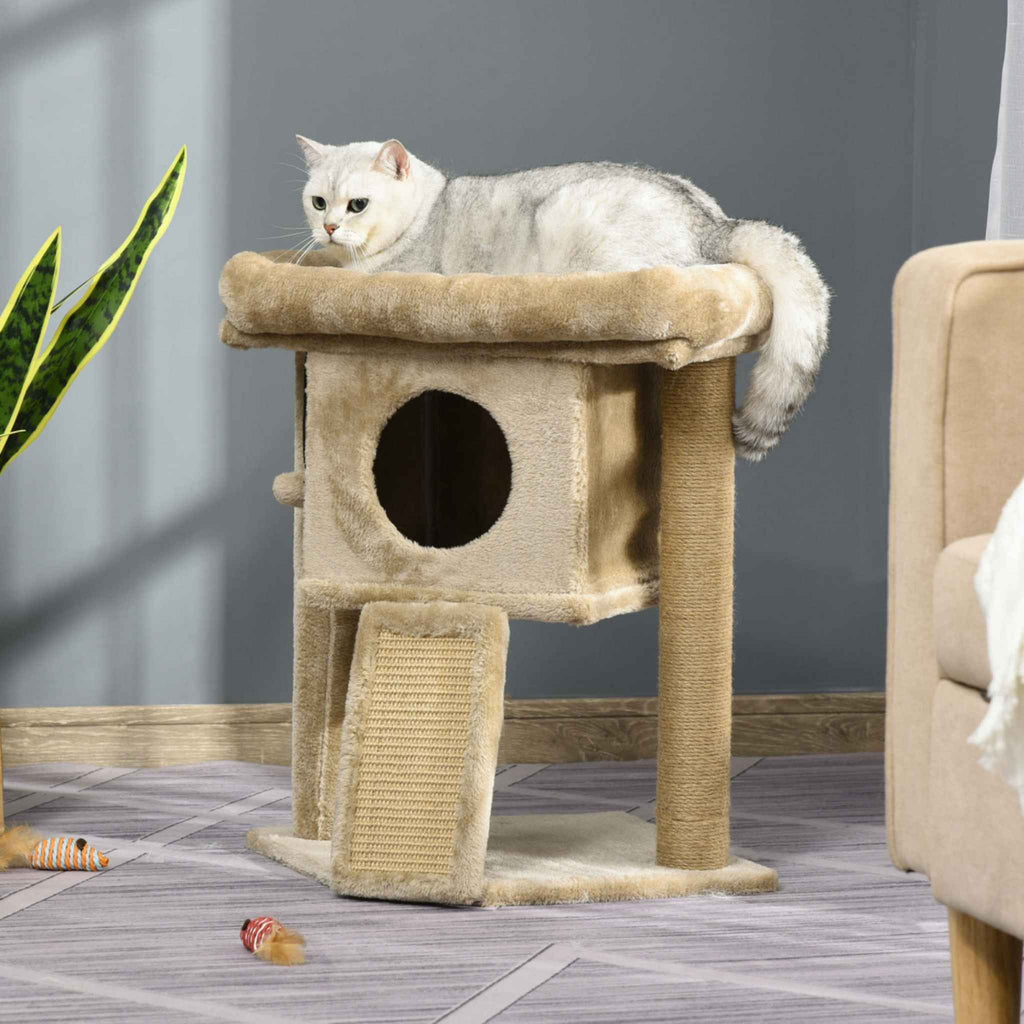 Cat laying on top level of beige cat tree