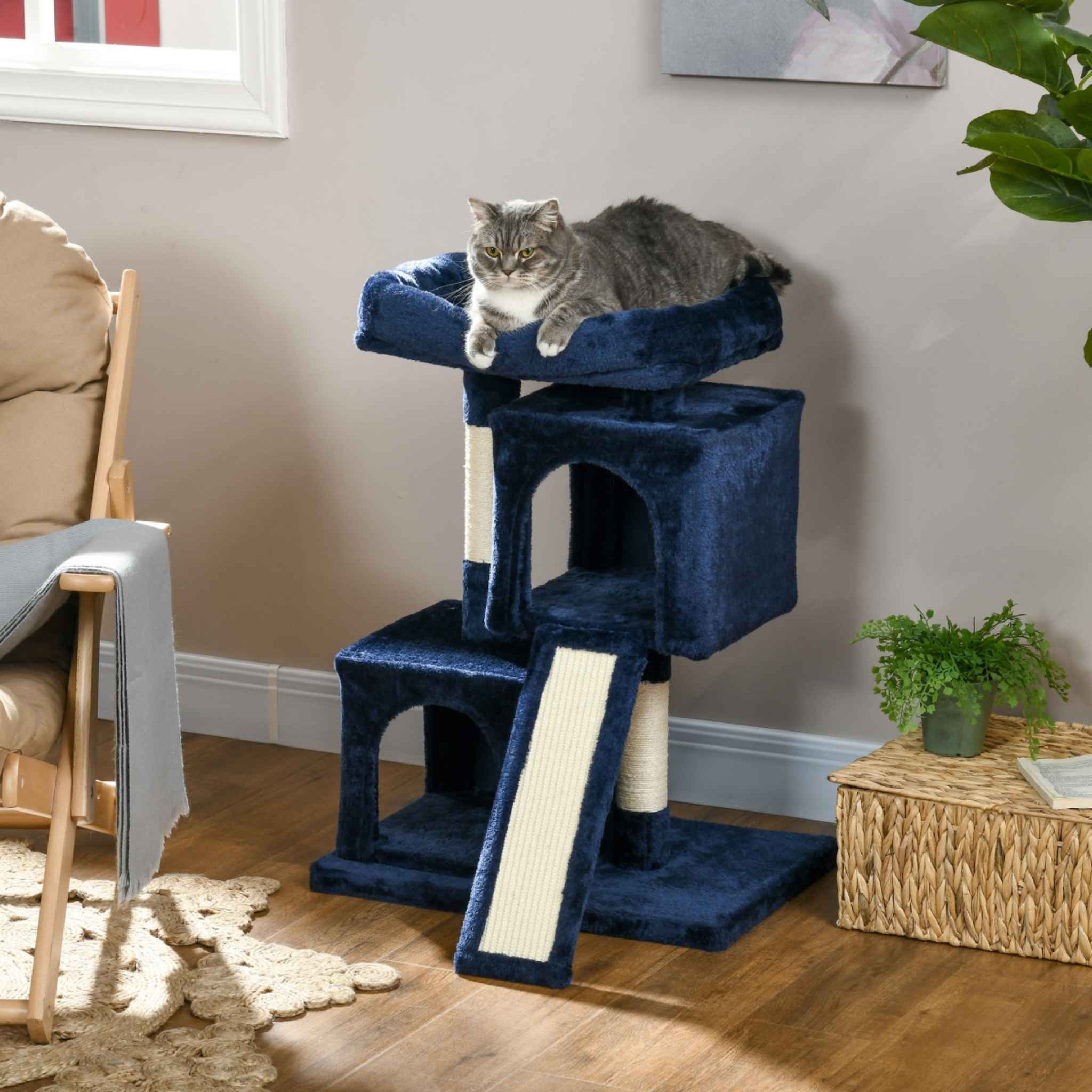 Cat laying on top perch of multi level blue cat tree