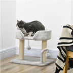 Cat laying on top perch of small grey cat tree