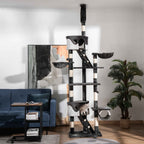 Cat playing on extra large dark grey cat tree in living room