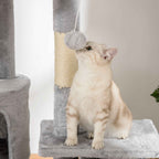 Cat playing with dangling toy on tall cat tower