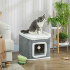 Cat resting on top perch of cat cave
