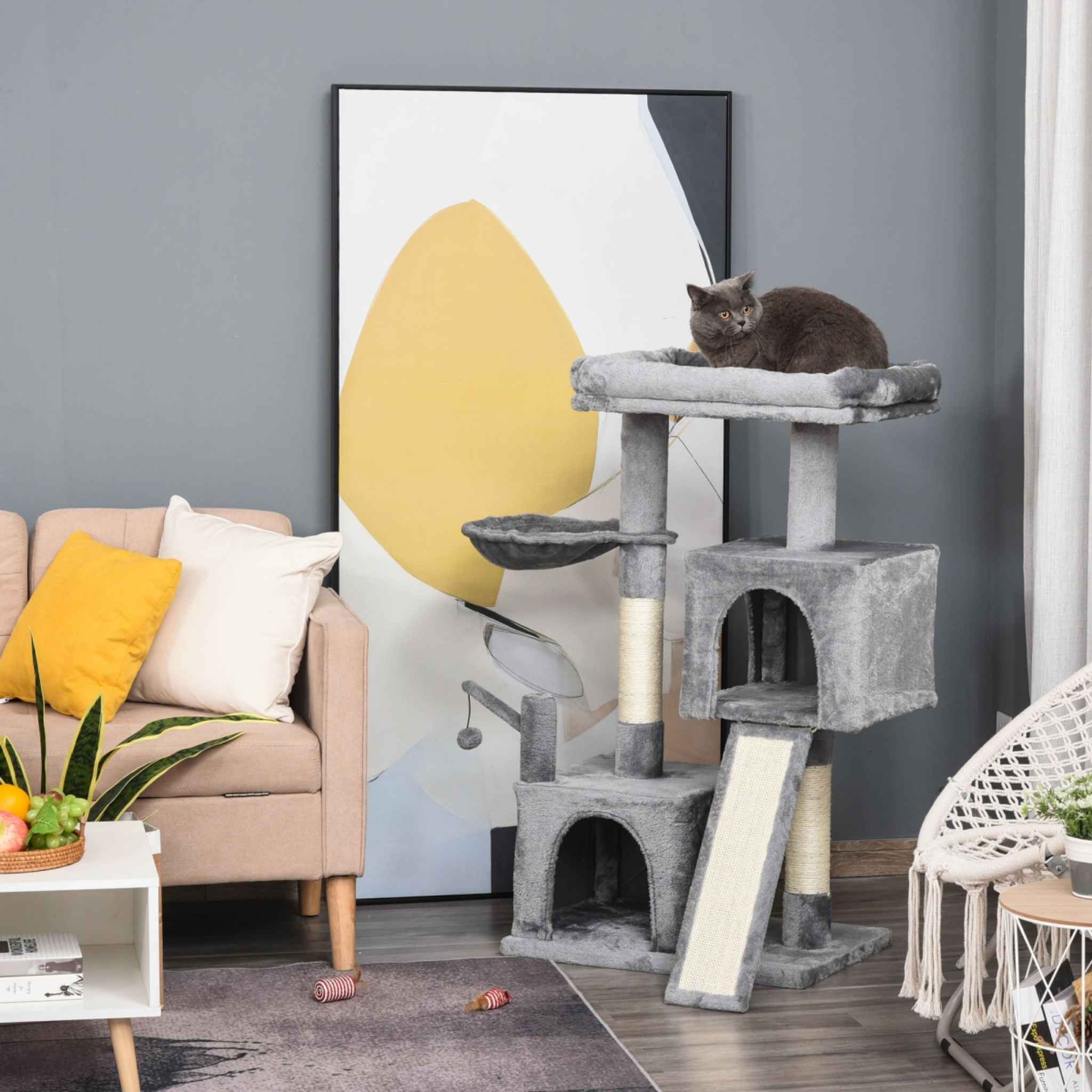 Cat resting on top perch of large grey fabric cat tree