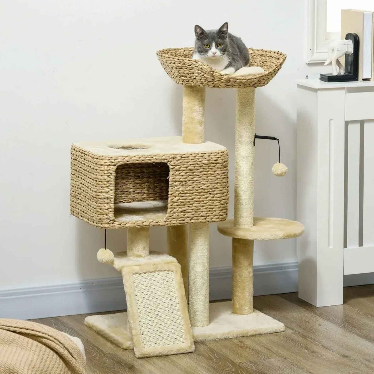 Cat resting on top perch of wicker cat tree