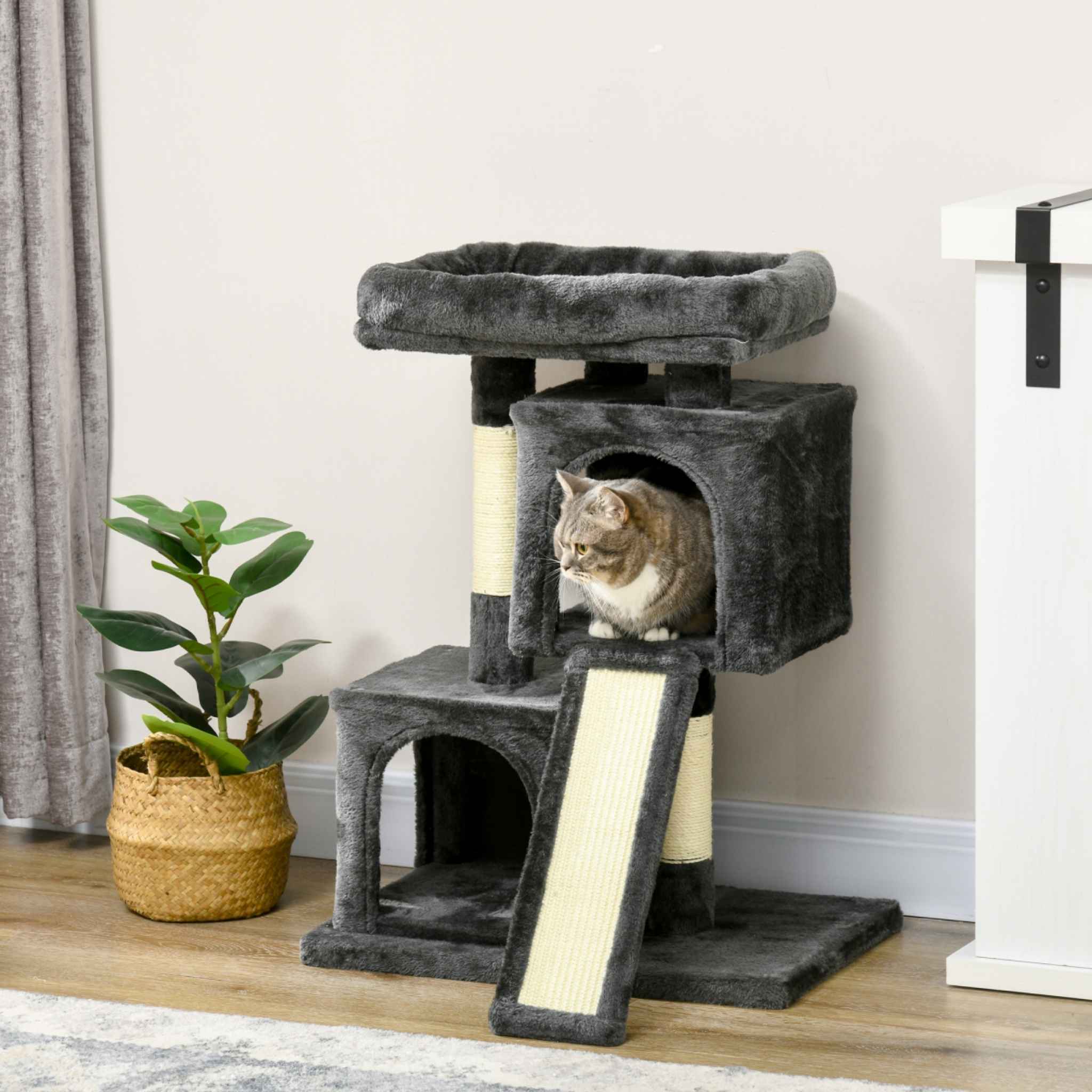 Cat sitting in grey cat tree