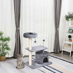 Cat sitting next to grey cat tower in living room