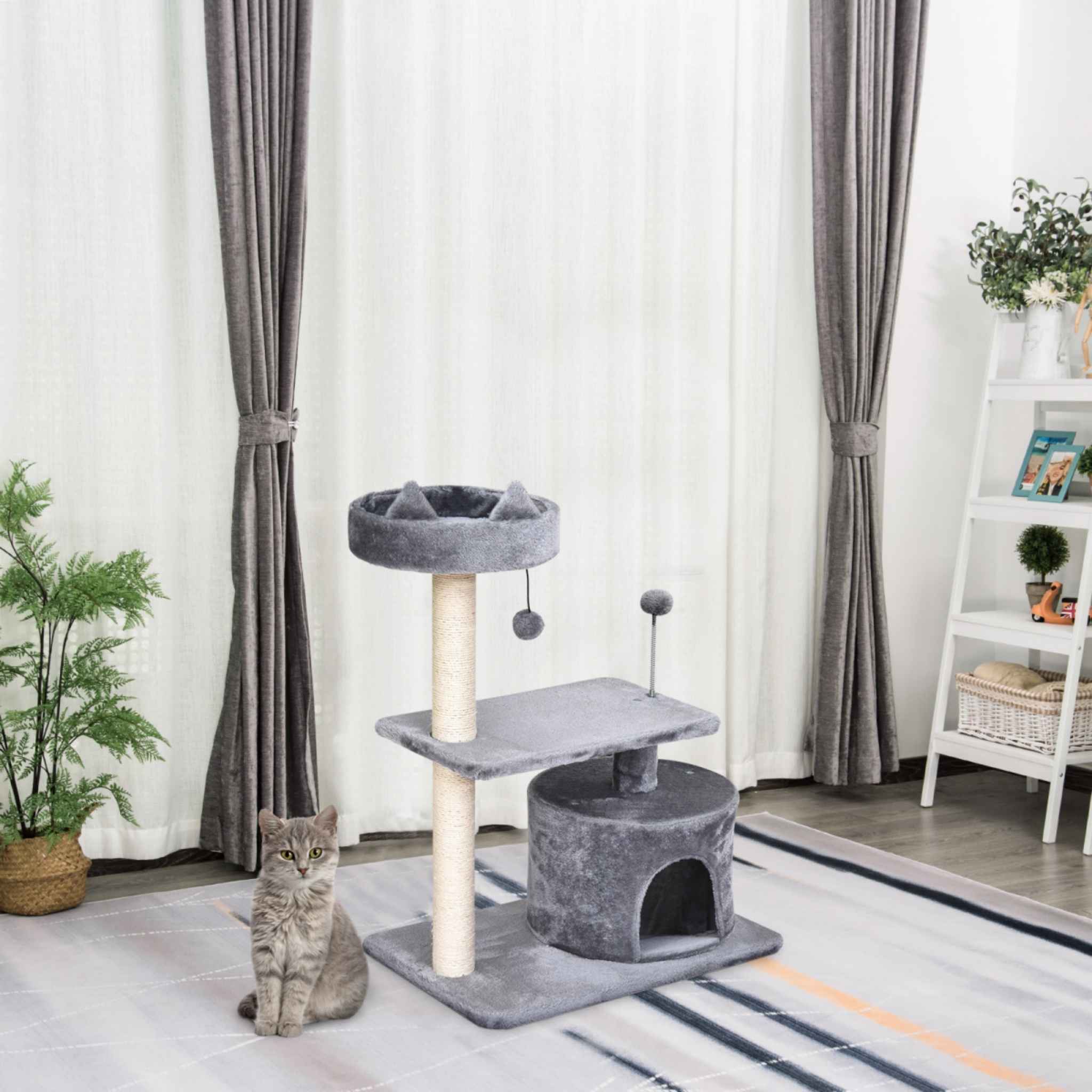 Cat sitting next to grey cat tower in living room