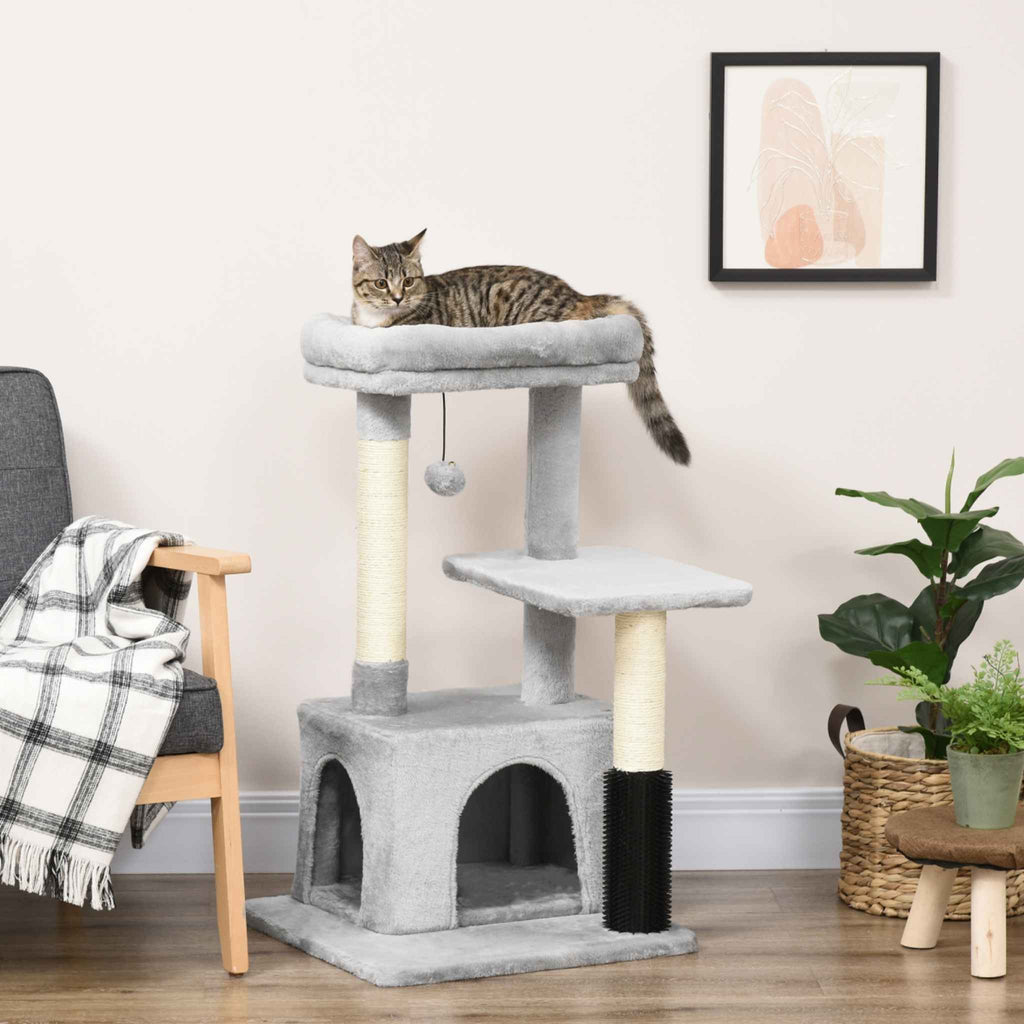 Cat sitting on top perch of multi-level grey cat tree