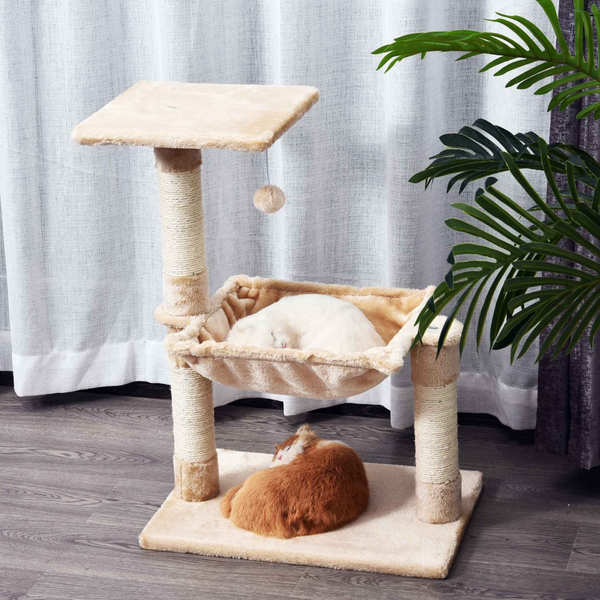 Cat sleeping on cream cat tower