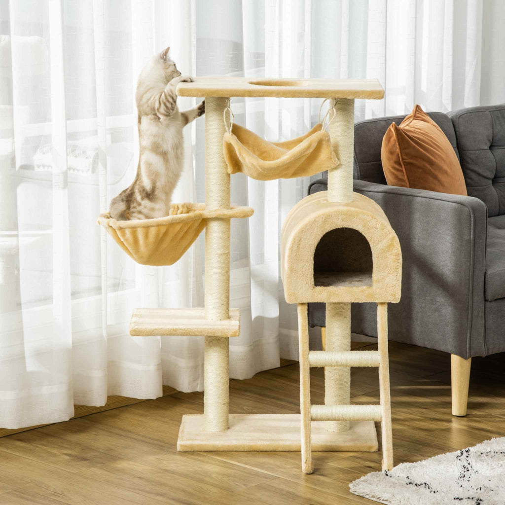 Cat stretching on cat tree with beige cushioned fabric platform in a living room.
