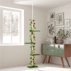 A tall cat tree with jute rope pole, green artificial grass platforms, and ivy vines, shown in a bright room next to a window and a green cabinet