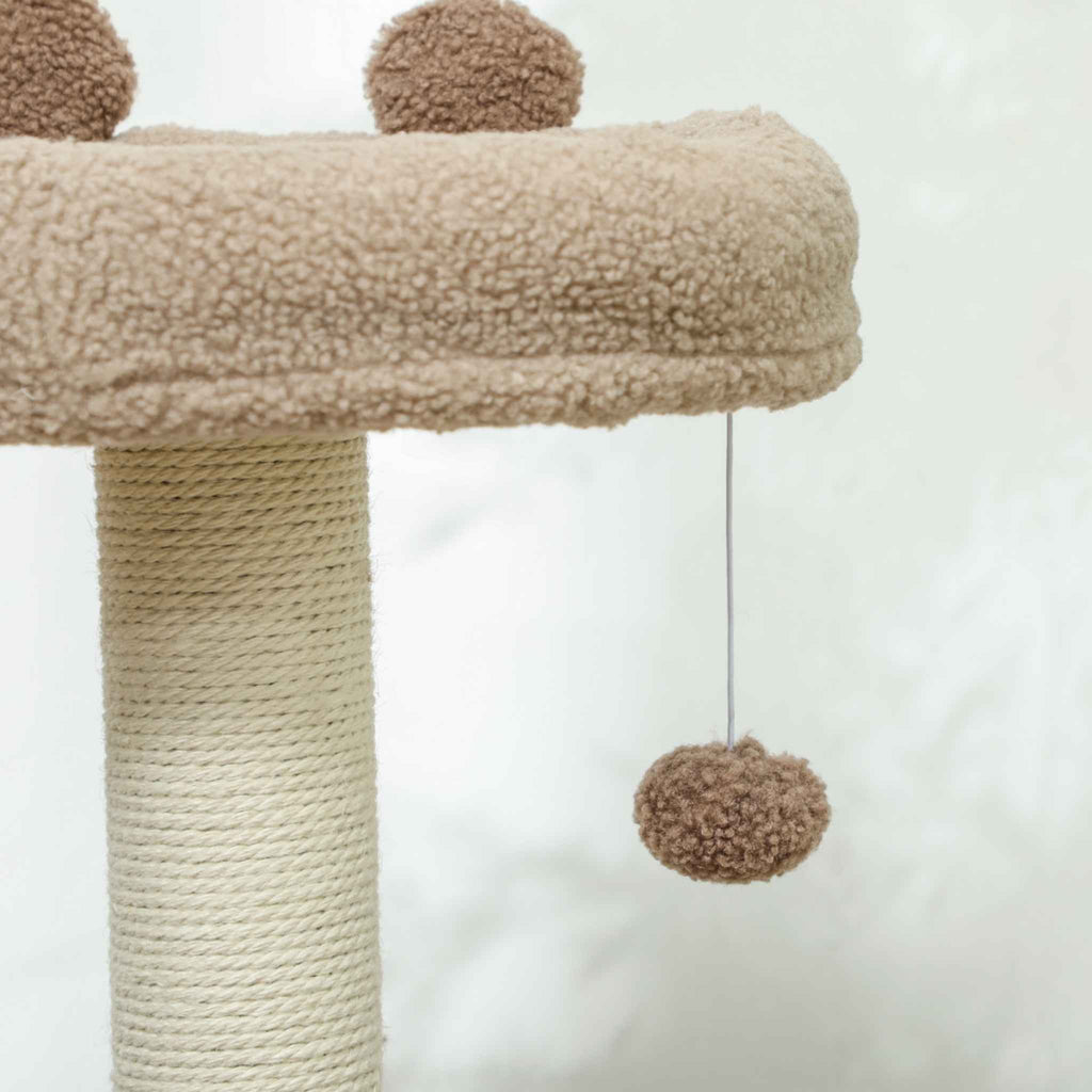 Dangling toy on a brown cat tree
