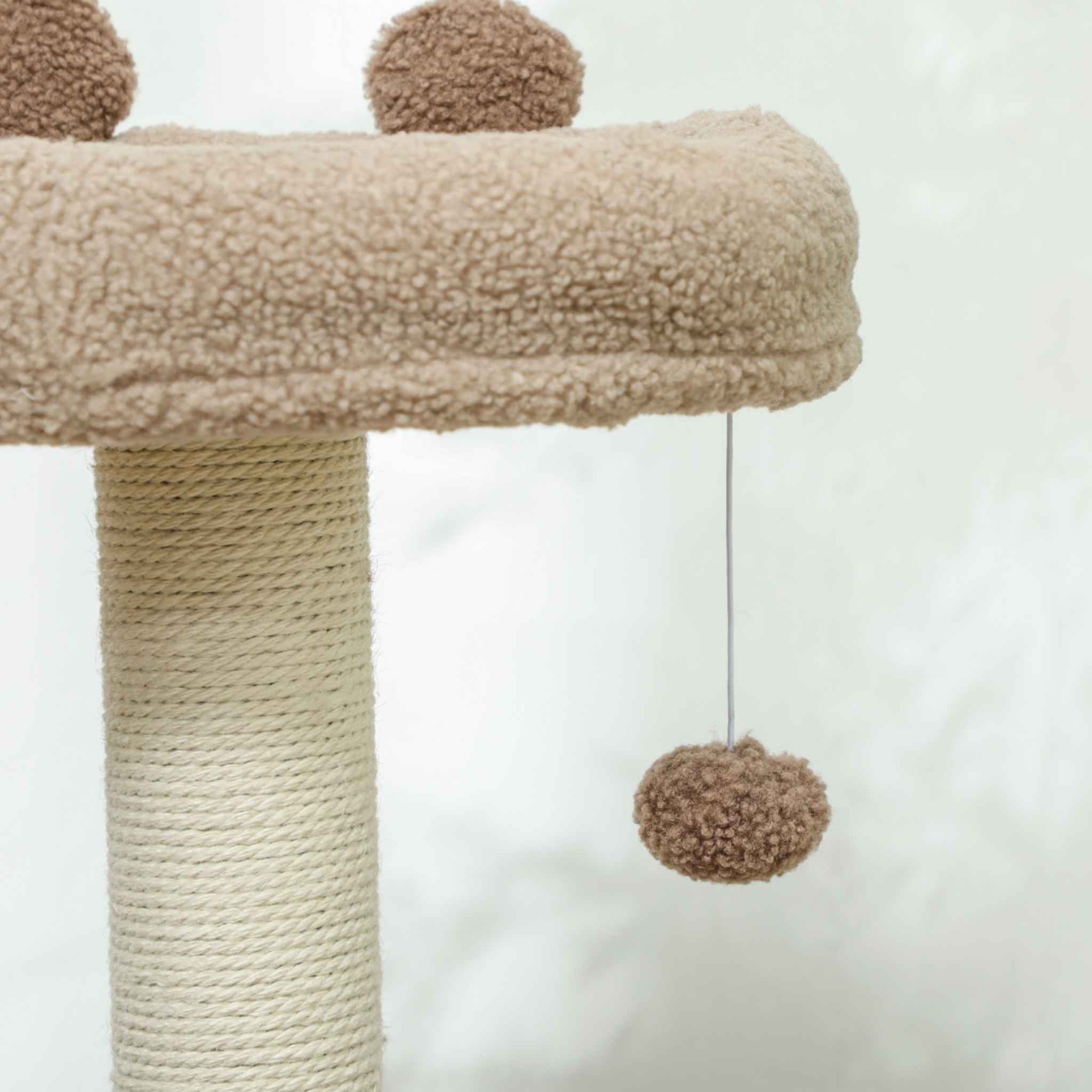Dangling toy on a brown cat tree