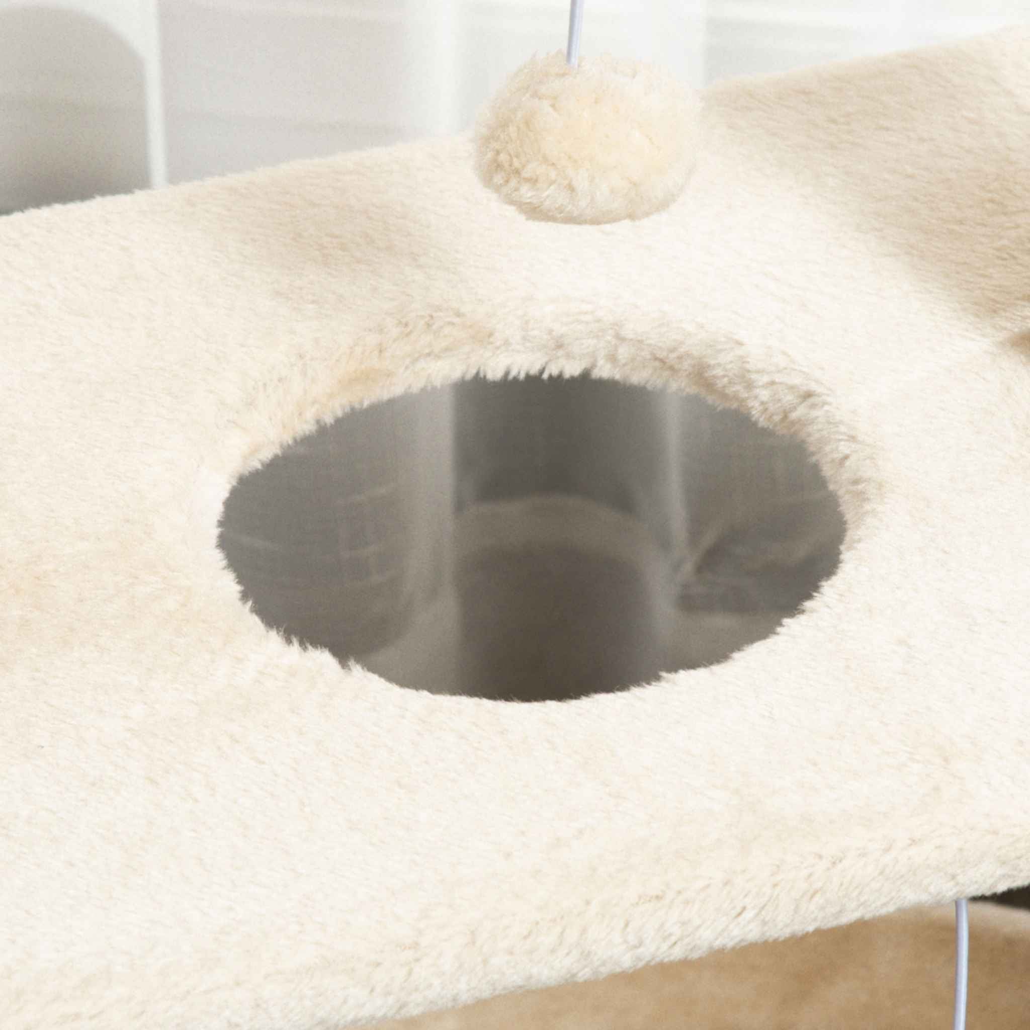 Dangling toy on cream cat tree