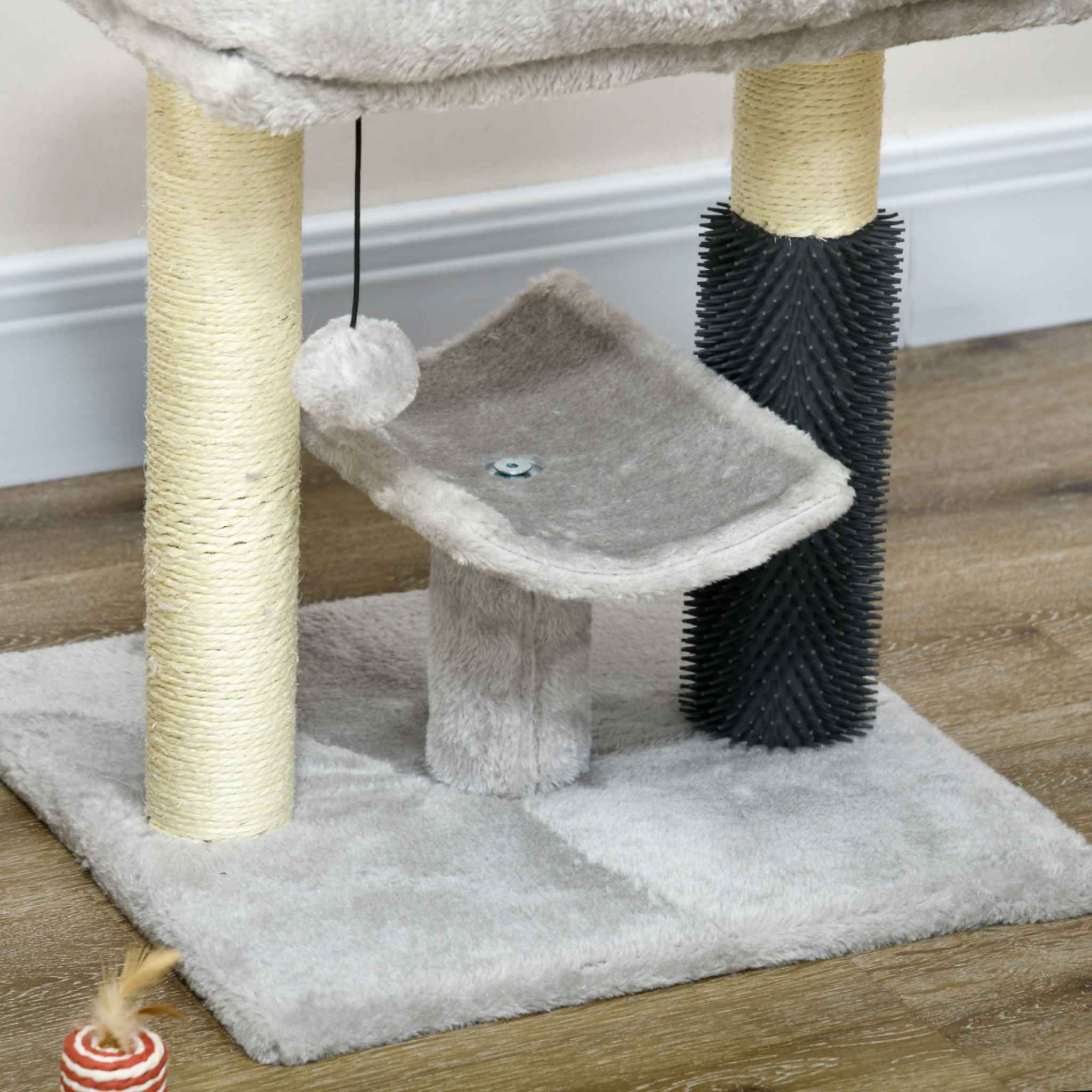 Dangling toy on light grey cat tree