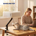 Dangling toy on white cat desk bed