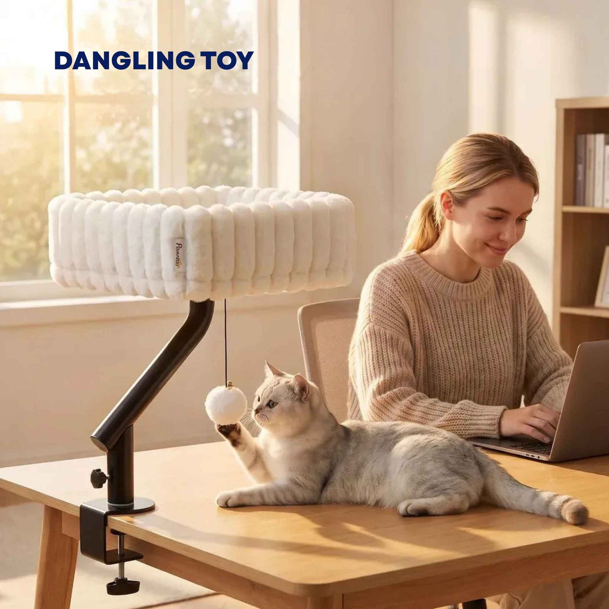Dangling toy on white cat desk bed