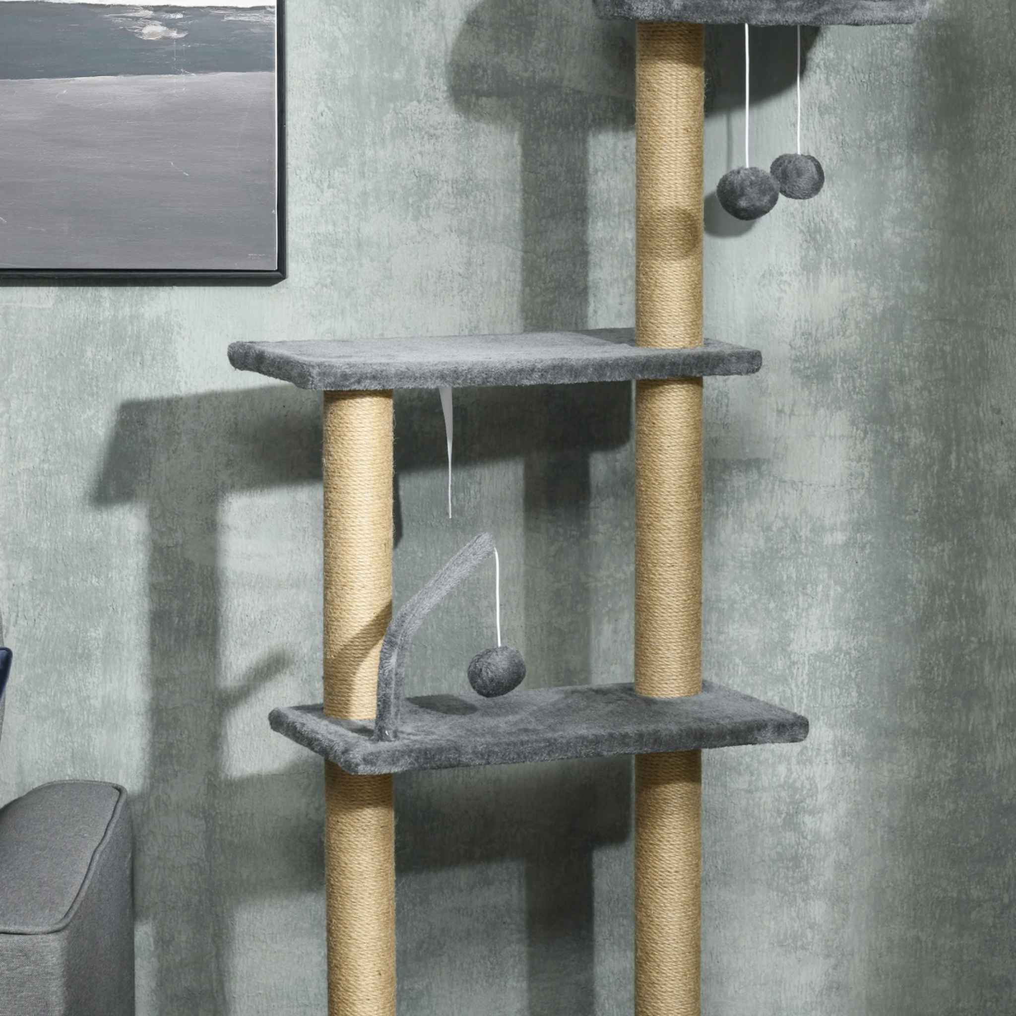 Dangling toys and jute rope on floor to ceiling cat tree