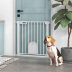 Dog sitting in front of narrow white dog gate with cat door