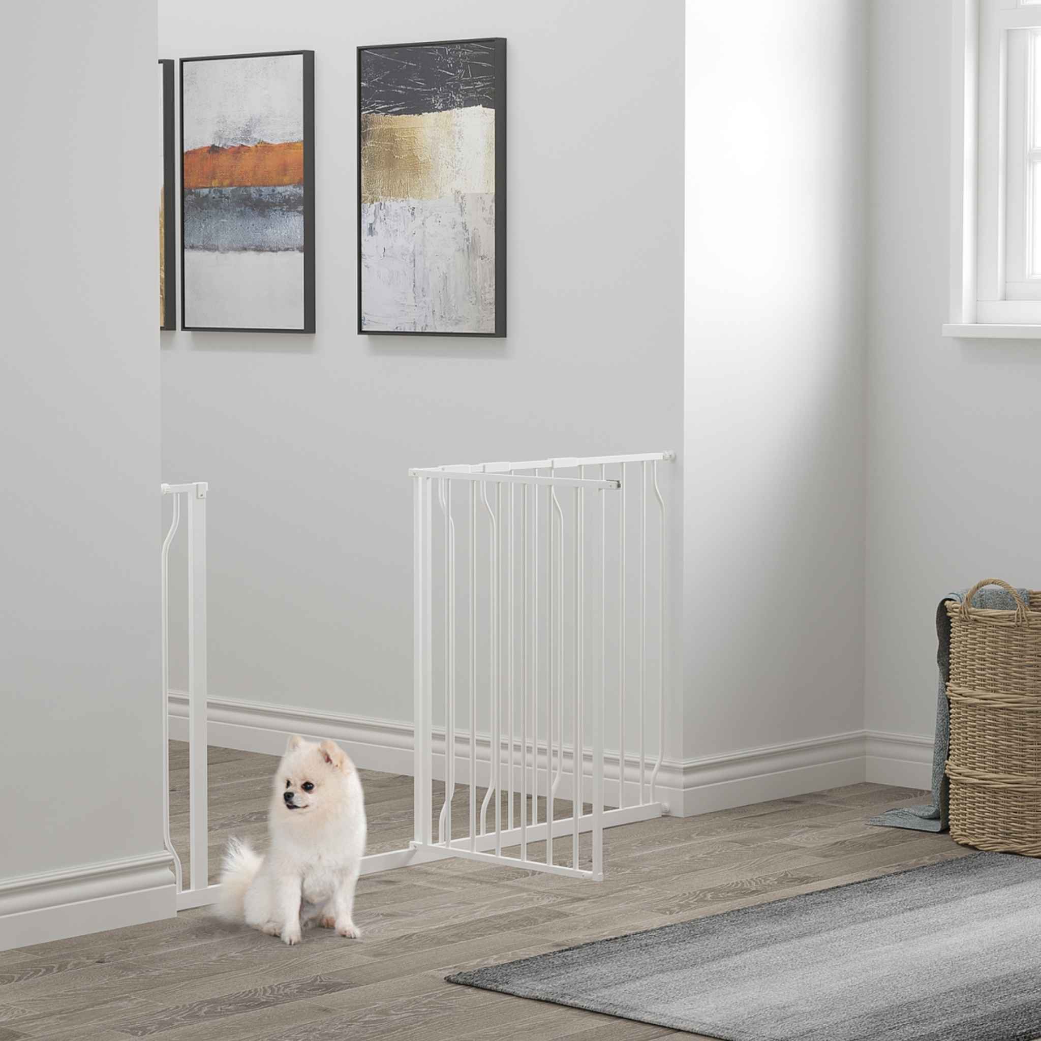 Dog sitting in front of wide white pet barrier in hallway