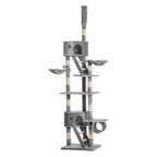 A tall multi-level cat tree with gray fabric-covered platforms, cat beds, scratching posts wrapped in cream and grey striped material, and a top perch.