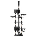 A tall dark grey cat tree with multiple levels, platforms, scratching posts, a ladder and houses
