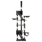 A tall dark grey cat tree with multiple levels, platforms, scratching posts, a ladder and houses