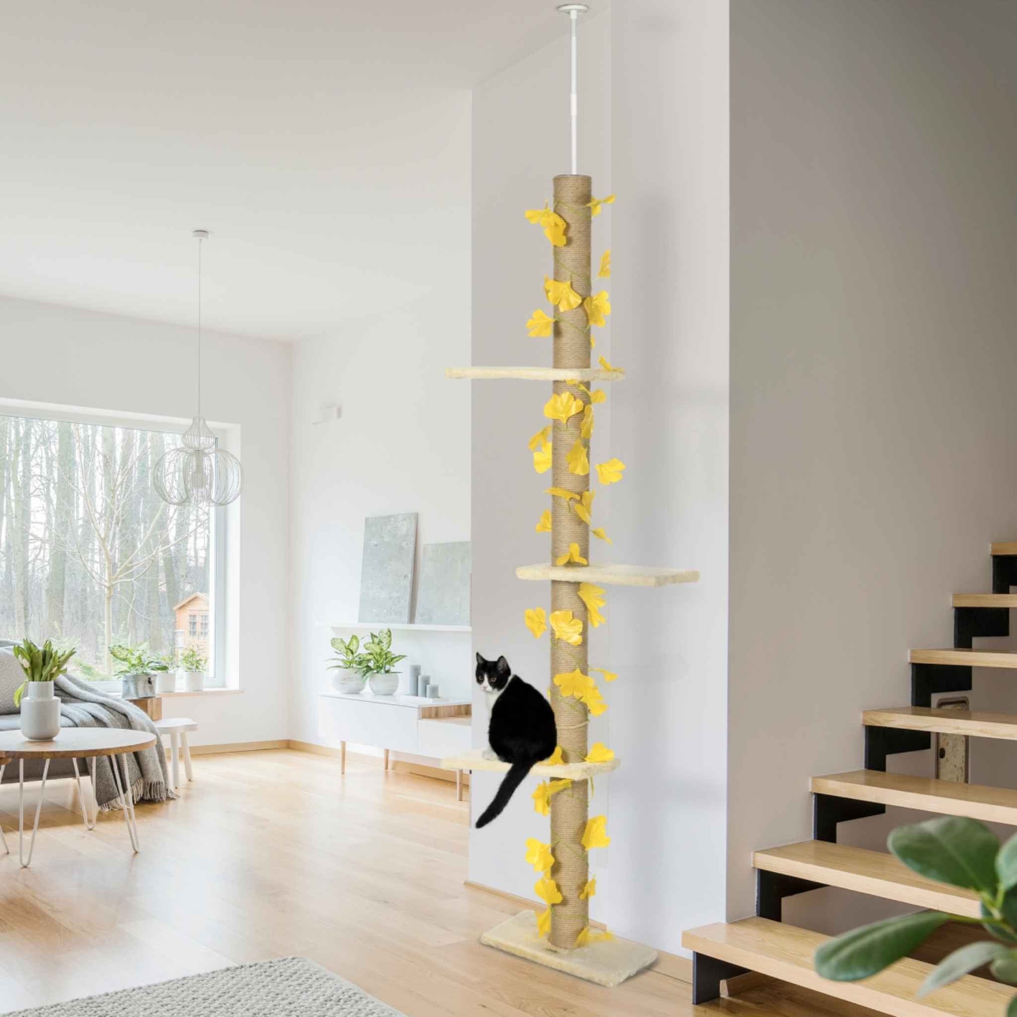 Floor-to-ceiling cat tree with leaves in living room