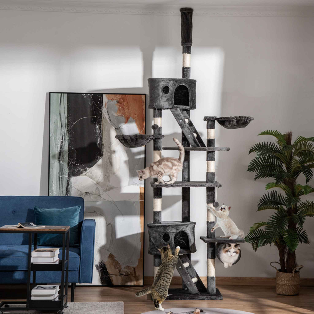 Cat tree with multiple cats playing in a living room