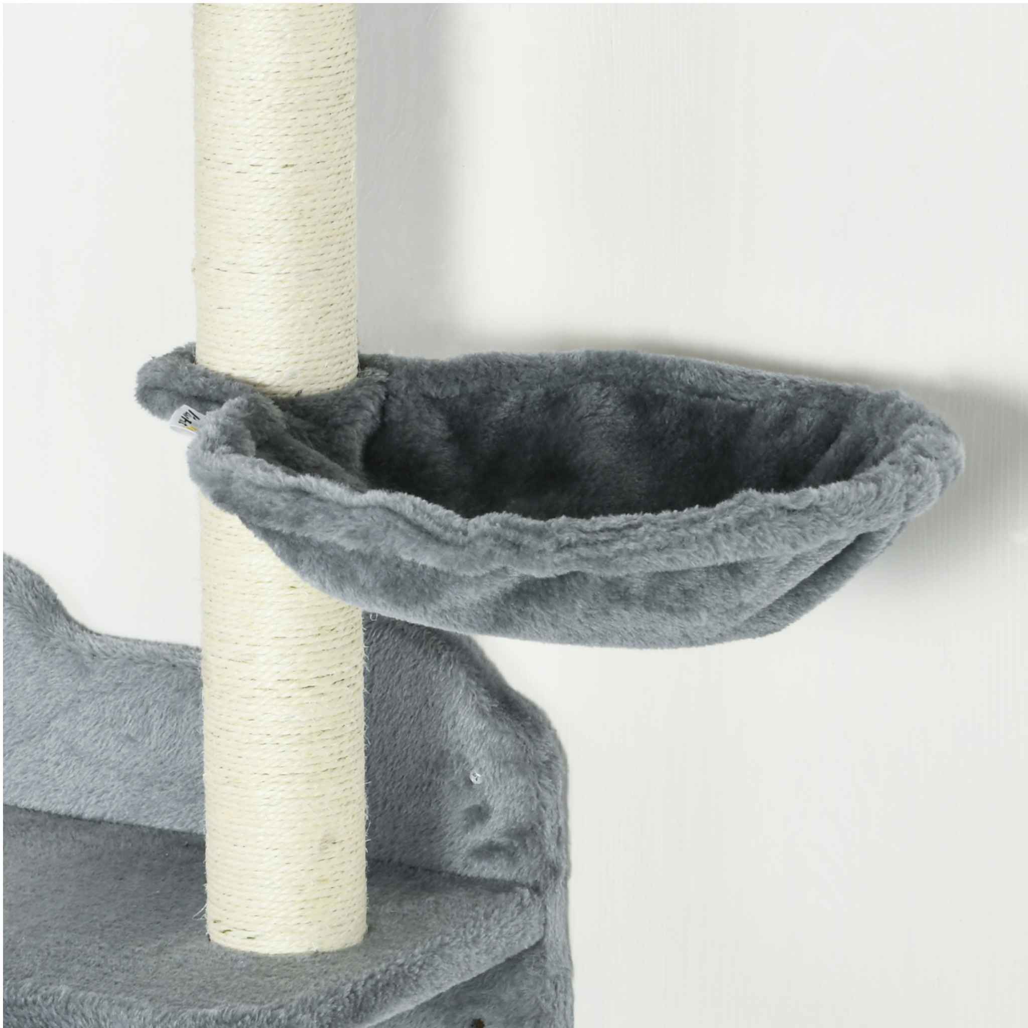 Close-up of a grey plush cat tree perch with a vertical scratching post