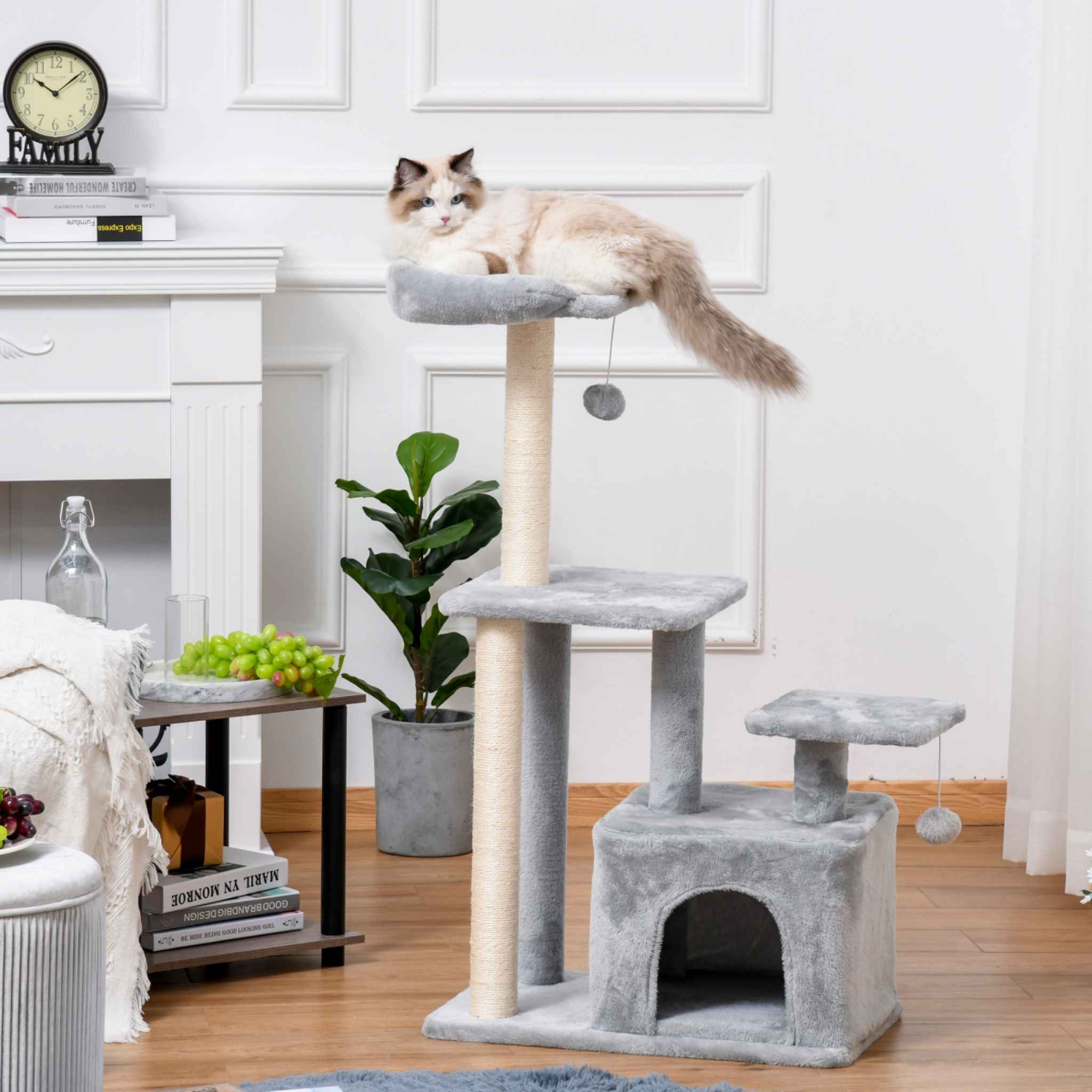 Grey cat tree in living room with cat on the top level