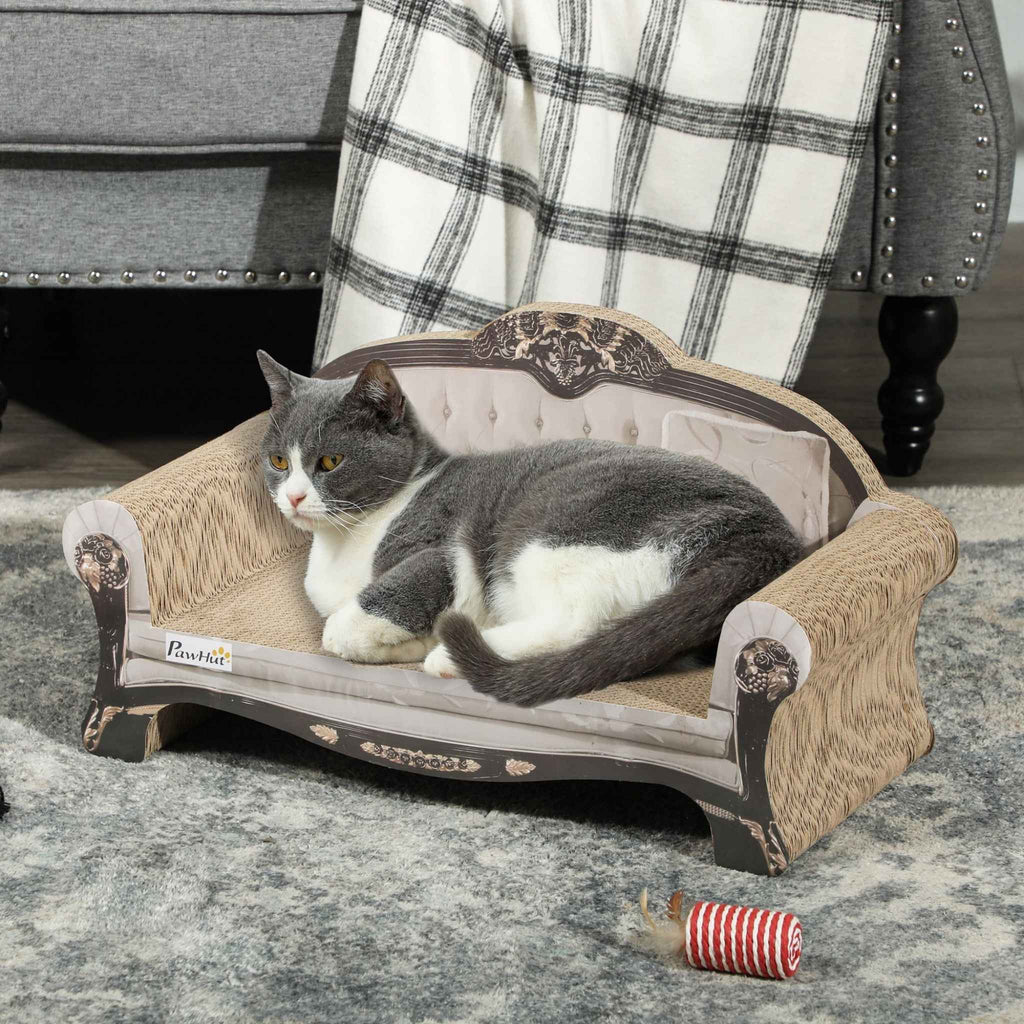 Grey tom cat laying on cream cat scratcher sofa