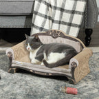 Grey tom cat laying on cream cat scratcher sofa