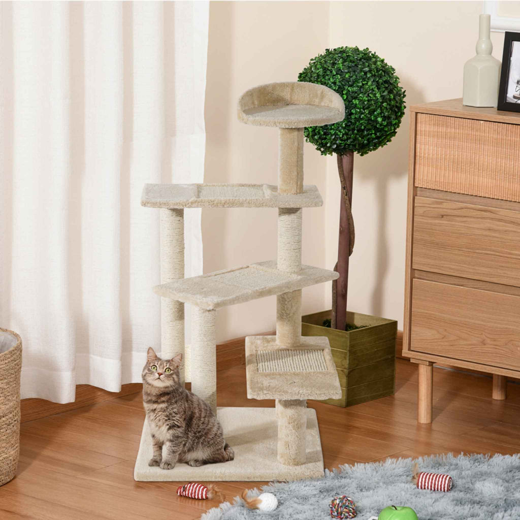 Kitten sitting on beige cat tree tower