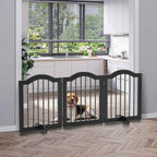Medium sized dog sitting behind black wooden dog gate in doorway