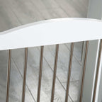 Metal bars on white freestanding pet gate