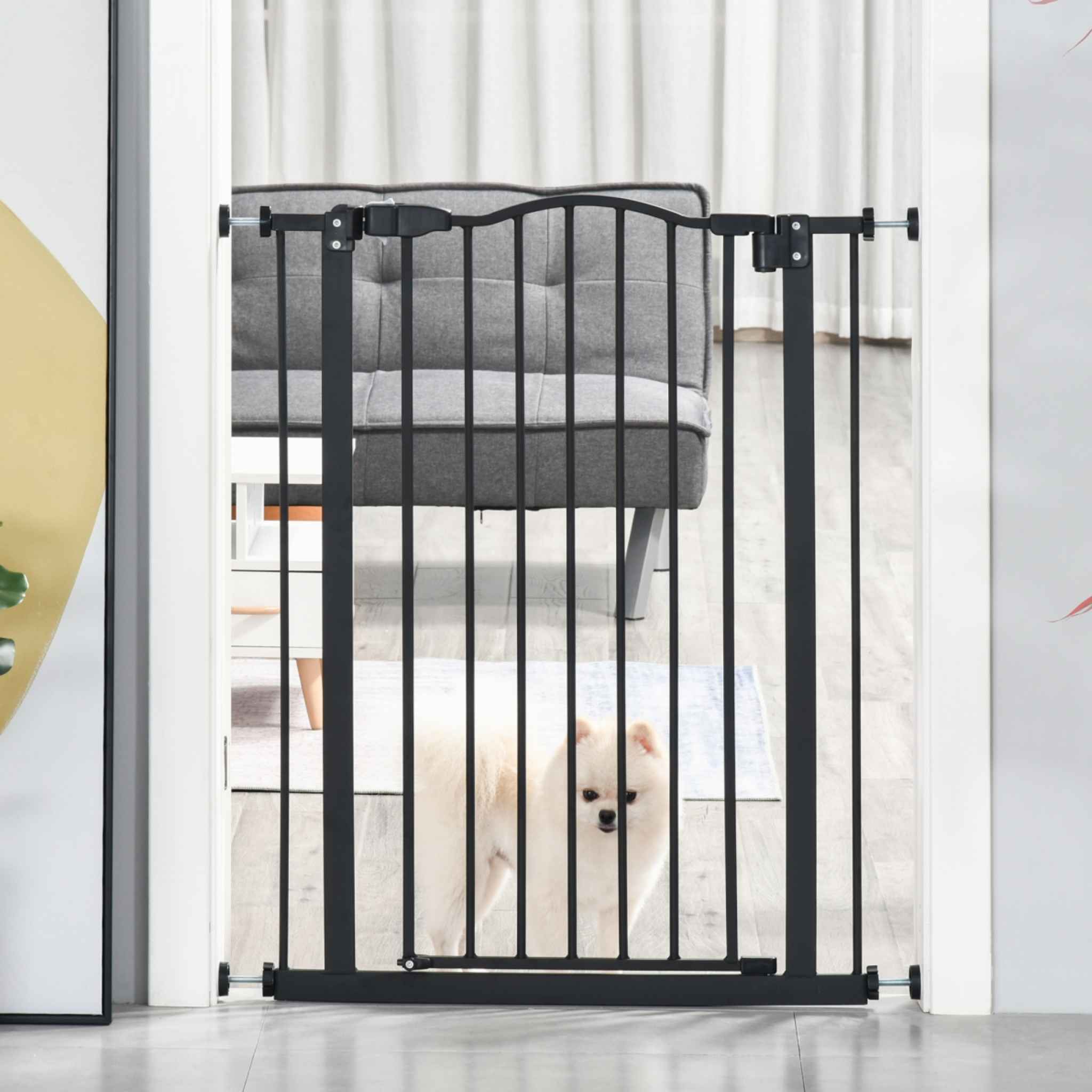Narrow black pet gate in doorway