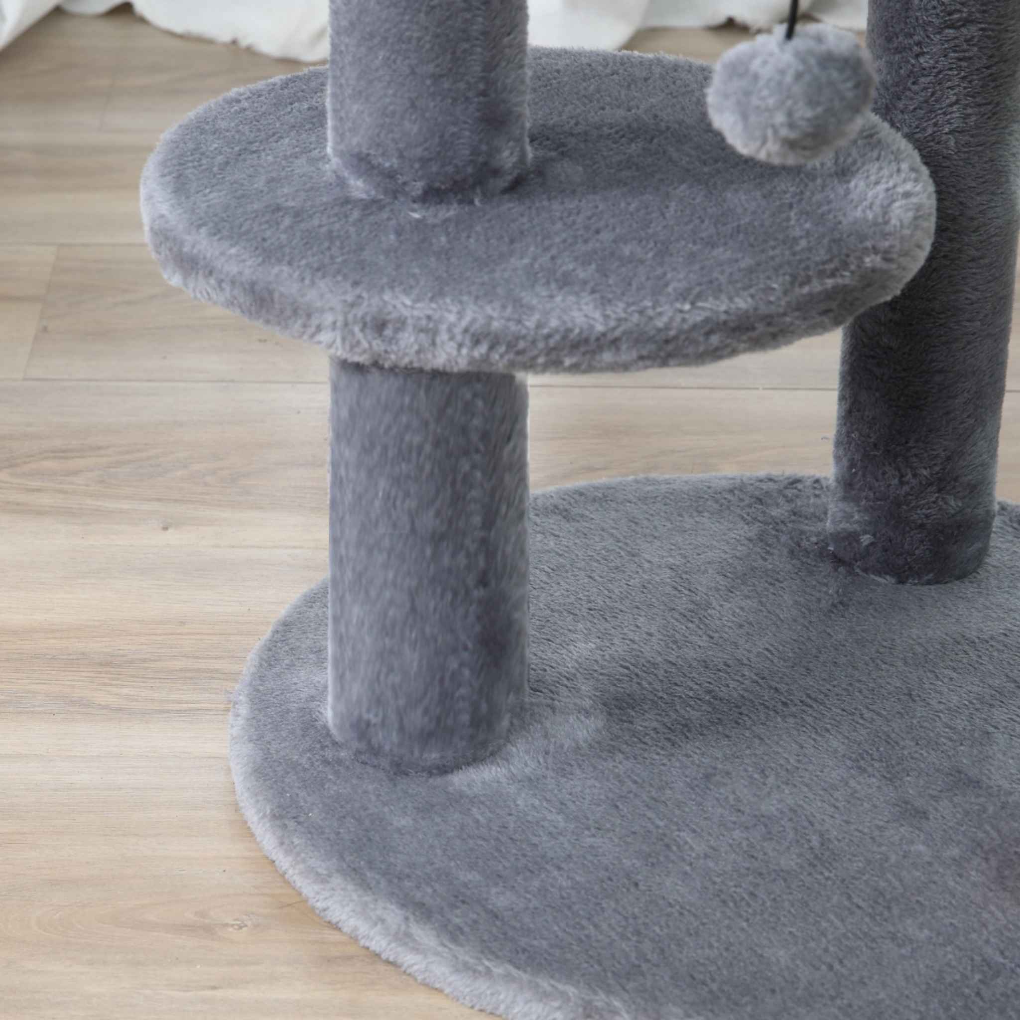 Platform and dangling toy on grey cat tree